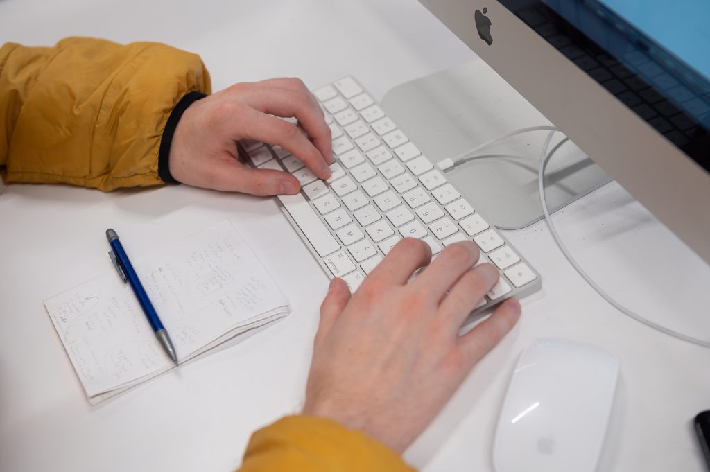 Photo of a students hands working on a computer