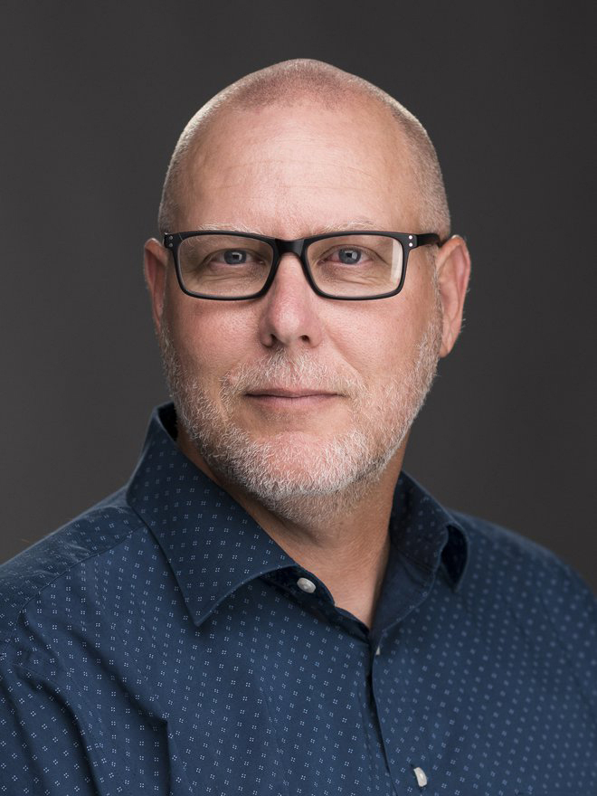 Headshot photograph of graphic design professor John Decker.