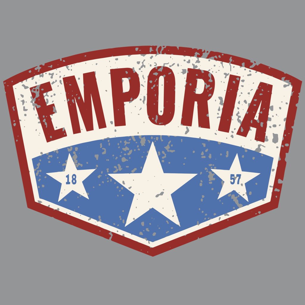 A old diamond shaped distressed teeshirt graphic with the colors red, white, and blue with the city name "Emporia" and below the founding date "1857"
